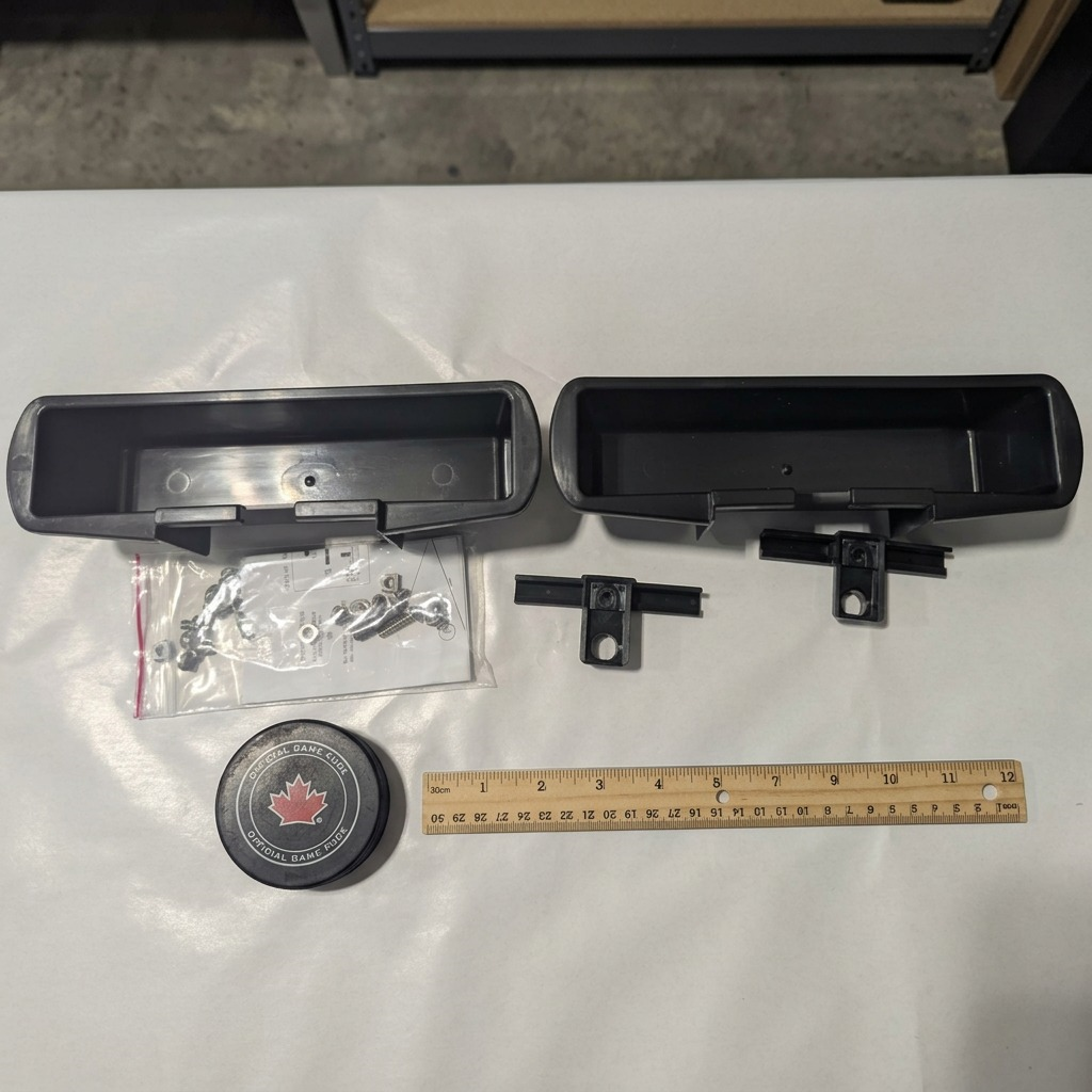 RAKABOT Titan 2 Containers and Black Hooks Kit shown for scale next to a ruler and hockey puck.
